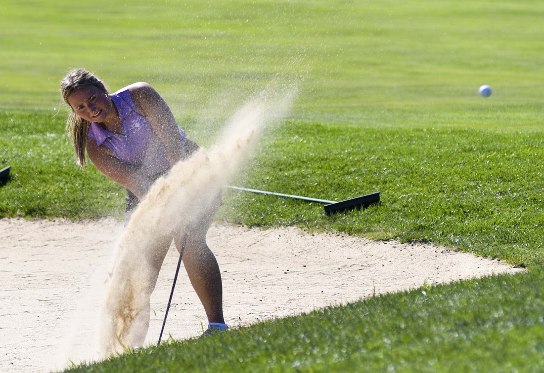 Fort Recovery High School senior Olivia Knapke hits out of a bunker on the 16th hole at PipeStone Golf Club during the OHSAA Division II district tournament on Wednesday. Knapke finished with 101 strokes on the day. (The Commercial Review/Andrew Balko)