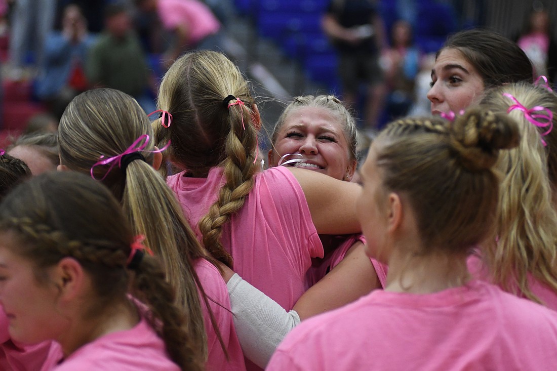 Jay County High School's Elizabeth Barnett embraces Maria Hemmelgarn after the Patriots clinched the Allen County Athletic Conference volleyball title with a 24-26, 25-23, 15-23, 25-23, 18-16 victory over Heritage on Thursday. Barnett pulled through in crunch time for JCHS, fueling comebacks in the fourth and fifth sets. (The Commercial Review/Andrew Balko)