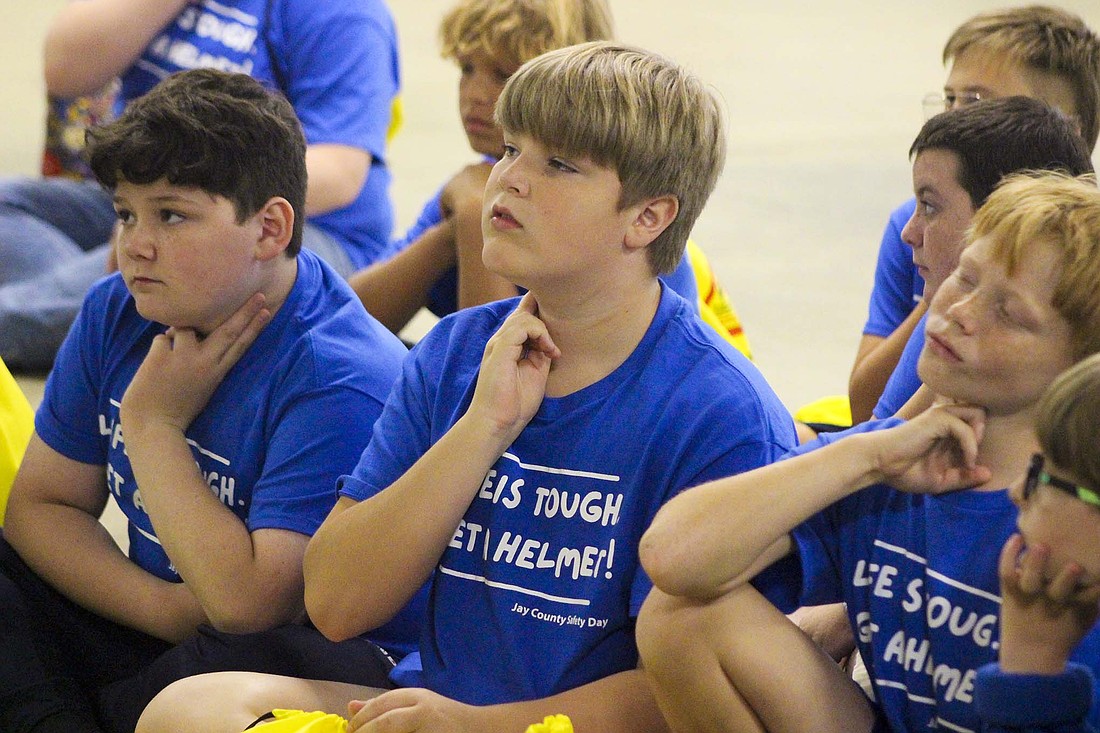 Fifth graders Kayden Blankenship, Gaven Robbins and Jerason Edwards check their pulses Thursday during Jay Emergency Medical Service’s presentation on Jay County Safety Day at Jay County Fairgrounds. Jay Emergency Medical Service gave safety tips and shared take home emergency supplies, including bandages, with students. (The Commercial Review/Bailey Cline)