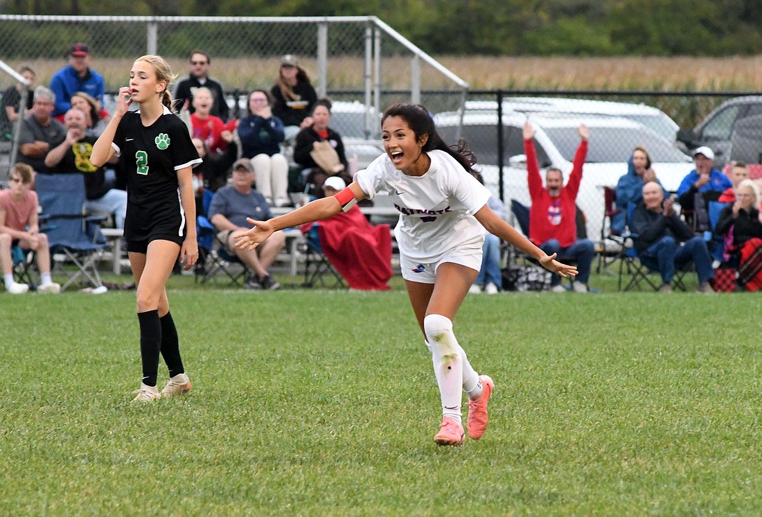 Jay County High School senior Aixa Lopez sprints towards London Lloyd (not pictured) with outstretched arms after scoring from 21 yards out against host Yorktown in the IHSAA Sectional 24 opener on Tuesday. It was one of three surprise celebrations for the Patriots as they scored all of their goals on long shots in their 3-1 victory that earned them a spot in tonight’s semifinal against Delta. (The Commercial Review/Andrew Balko)