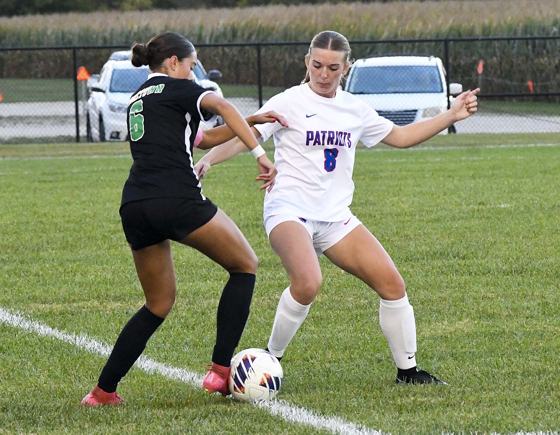 Ariel Beiswanger, the sweeper for the Jay County High School girls soccer team, pokes the ball away from host Yorktown’s Harper Mitchell during Tuesday’s 3-1 victory in the sectional opener. Beiswanger and the back line played a clean game, making only one mistake late in the second half to allow Hopkins a free kick that sailed over Maleah Parsons’ wing span. (The Commercial Review/Andrew Balko)