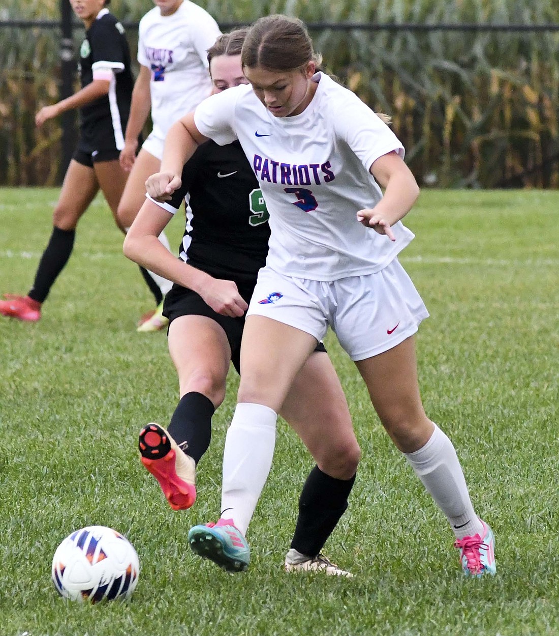 Avery Snow of the Jay County girls soccer team uses her body to shield the ball from Yorktown’s Analyn Hymas during the sectional opener that the Patriots won 3-1 on Tuesday. (The Commercial Review/Andrew Balko)