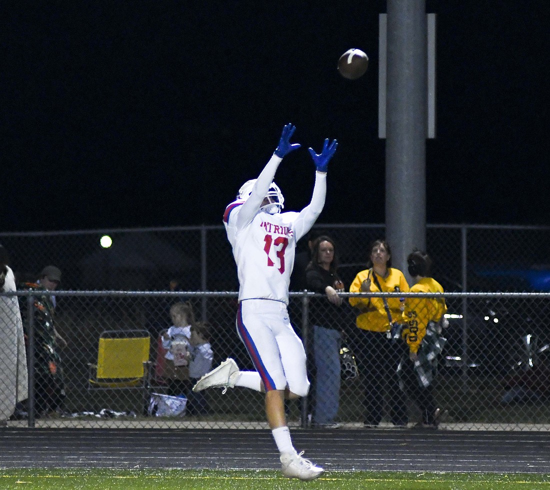 Jay County High School sophomore Tyler Wasson reels in a 13-yard pass from Nick Laux on the final drive of the Patriots’ 42-14 loss at Class 2A No. 3 Lapel on Friday. Wasson led the Patriots with 25 receiving yards on two catches. (The Commercial Review/Andrew Balko)