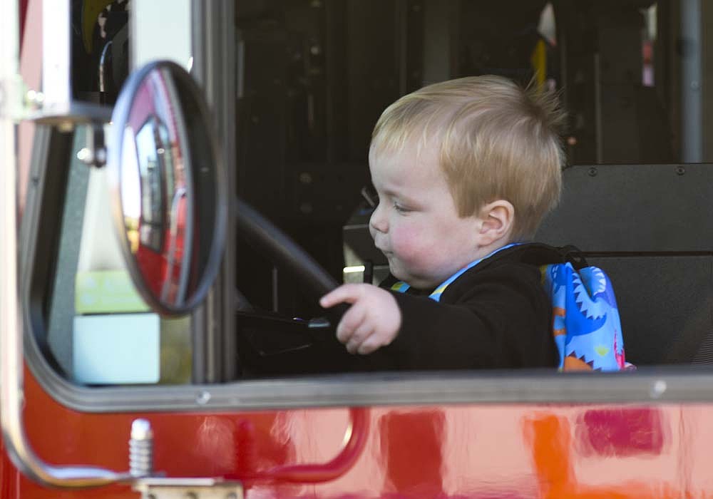 One-year-old Anthony Schroen of Portland pretends to drive a firetruck Saturday morning during Portland Fire Department's Fire Safety Day. The event included various fire department vehicles, information from first responders and visits with the department's dog Huey. (The Commercial Review/Ray Cooney)