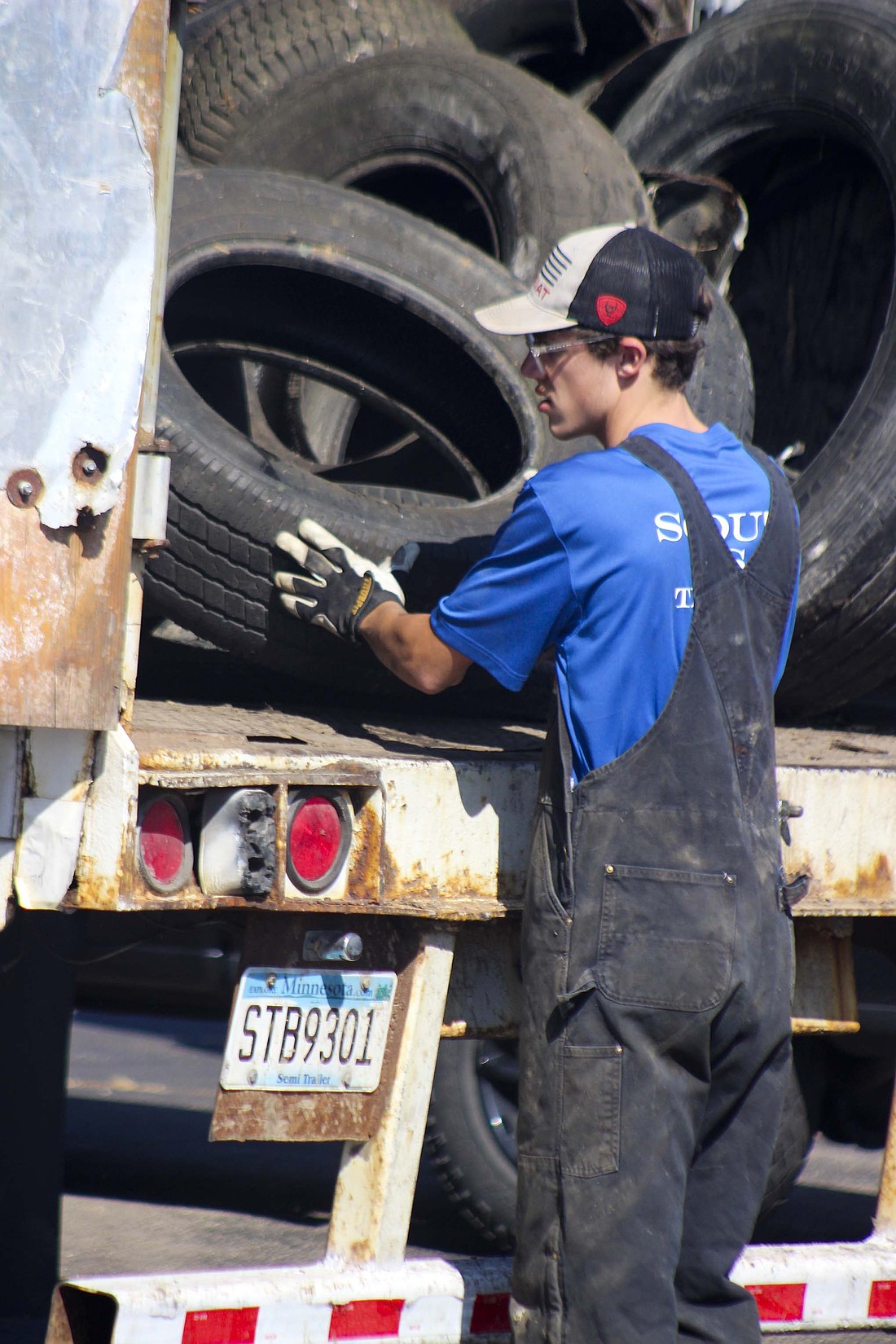 Austin Jellison, 18, throws a tire into the truck Saturday at Jay County Junior-Senior High School. Jay County Solid Waste Management District over the weekend hosted Jay County Tox Away Day, an annual event for local residents to donate toxic materials. (The Commercial Review/Bailey Cline)