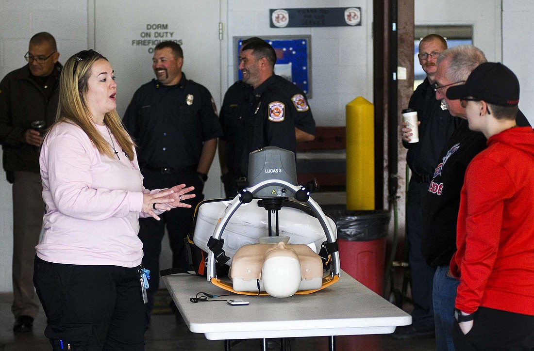 Jessica Curtis of Jay Emergency Medical Service explains and demonstrates the workings of a LUCAS device, which is used for automated chest compressions during CPR, during Portland Fire Department’s Fire Safety Day on Saturday. The event included a variety of safety-related activities and the opportunity to check out various emergency response vehicles. (The Commercial Review/Ray Cooney)