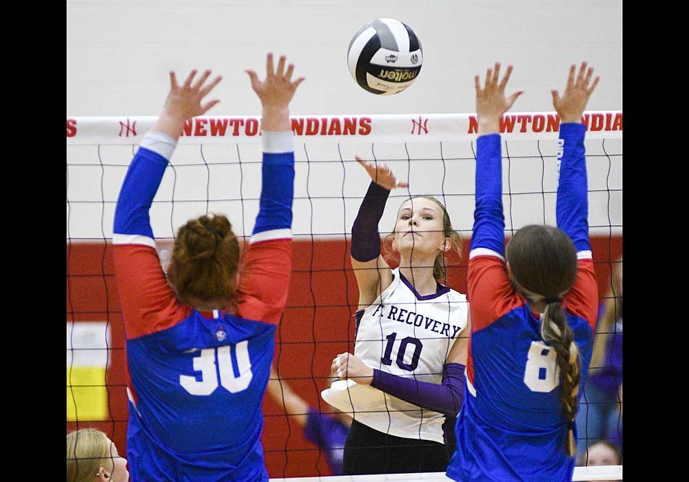 Fort Recovery High School freshman Hope Evers smacks the match-ending kill between Valerie Night (30) and Lily Zwiebel (8) of the Riverside Pirates on Wednesday. Her kill capped a 25-12, 25-7, 25-9 victory for the Indians in the opening round of the Division VI Southwest District tournament at Newton. (The Commercial Review/Ray Cooney)