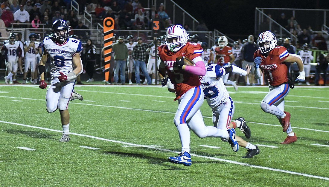 Aiden Phillips of the Jay County High School football team races downfield on a 37-yard reception in the fourth quarter of Friday’s 15-14 win over Heritage. The catch set up a 5-yard touchdown throw from Nick Laux to Phillips on fourth-and-goal with 7.4 seconds left, and Laux ran in the 2-point conversion for the game-winning points. (The Commercial Review/Ethan Oskroba)