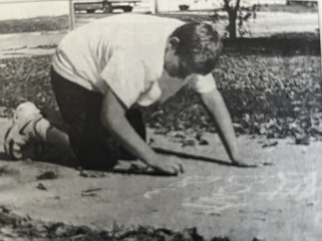 East Elementary School Just Say No club member Justin Foss writes an anti-drug message in chalk on the sidewalk in front of the school in 2000. Jay School Corporation was gearing up for Red Ribbon Week, an annual drug prevention and awareness campaign. (The Commercial Review/Laurie Chen)