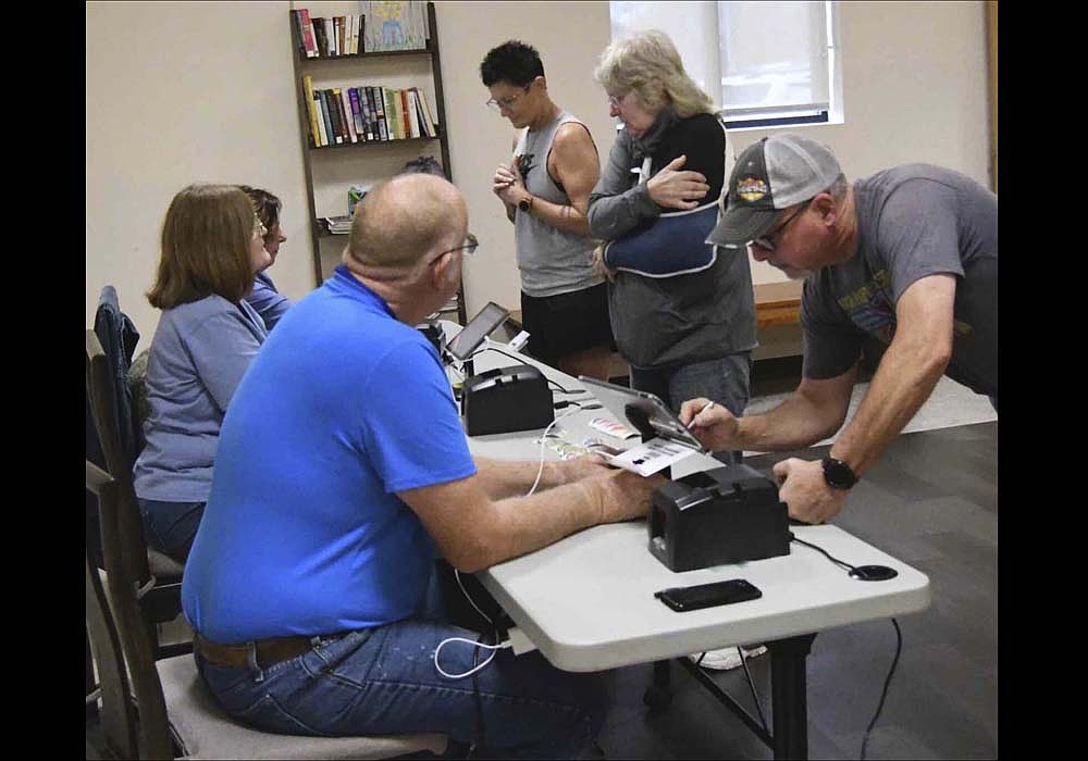 Poll workers assist visitors checking in to vote on Nov. 5, 2024, at Jay Community Center in Portland. Jay County Election Board approved a resolution Thursday to adopt the county’s vote center plan. Beginning with the 2026 primary election, the county will use vote centers at Jay Community Center in Portland and West Jay Community Center in Dunkirk. (The Commercial Review/Ray Cooney)