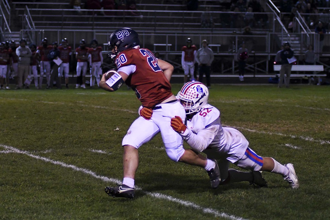 Garrett Dillon of the Jay County High School football team begins to tackle Bellmont’s Jason Lykins before he can get back to the line of scrimmage on Friday. The JCHS defense tackled Braves for a loss on six plays in the IHSAA Class 3A Sectional 28 opener that it won 35-0. (The Commercial Review/Andrew Balko)