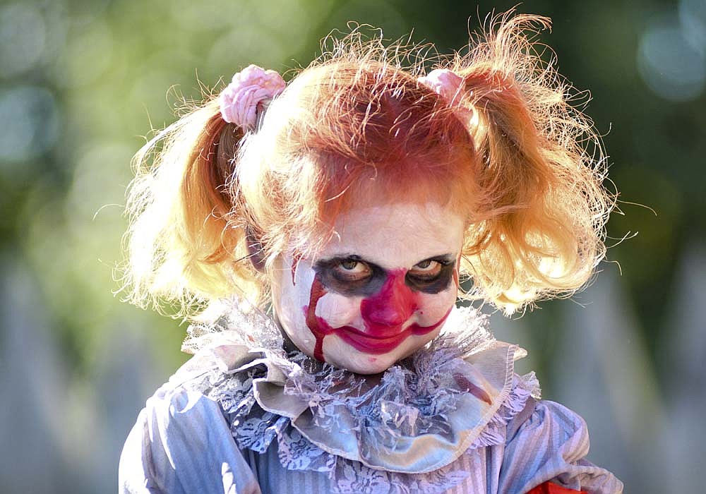 Six-year-old Quin Champ, dressed as Pennywise, looks out at those in attendance Sunday afternoon for the Fort Recovery Halloween costume contest at Hein Amphitheater in Van Trees Park. Champ won the award for spookiest costume. (The Commercial Review/Ray Cooney)
