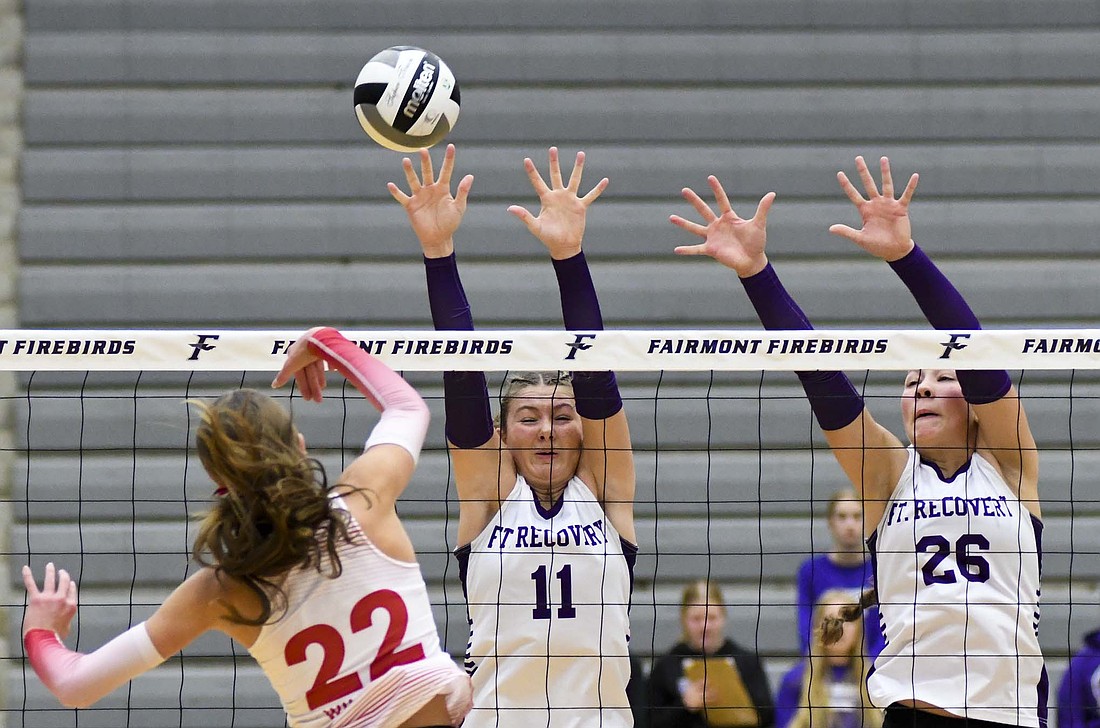 Fort Recovery High School’s Kayden Ranly (11) blocks an attack by Olivia Burks of Houston on Saturday during the OHSAA Division VI Southwest 3 District championship at Fairmount. The Tribe took down the Wildcats in the minimum with a 25-11, 25-12, 25-14 victory to claim its second consecutive district title. (The Commercial Review/Andrew Balko)