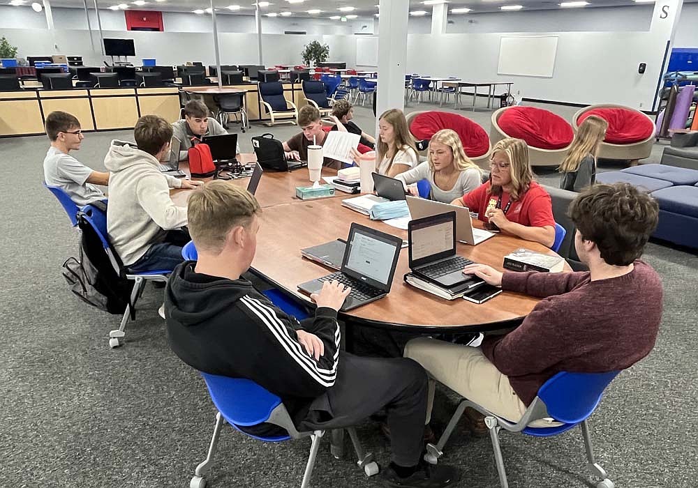 Students returned to the junior high and Instructional Media Center (library) wing of Jay County Junior-Senior High School on Monday for the first time since the September 2024 tornado. Pictured, librarian Cathy Fugiett reviews progress with students who are taking courses for college credit. (The Commercial Review/Ray Cooney)