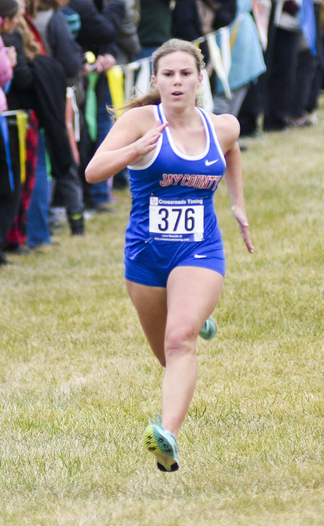 Brooklynn Byrum of Jay County High School sprints toward the finish line on the Huntington University cross country course during Saturday’s regional meet. The sophomore finished 87th in 21 minutes, 01.8 seconds. Ava May was the only teammate to finish above her. (The Commercial Review/Ray Cooney)