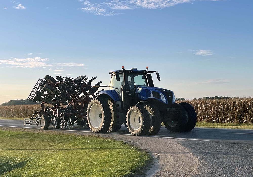 Joe Wuebker of Fort Recovery drives a tractor on Indiana 67 near its intersection with county road 800 East on the evening of Friday, Sept. 10. Columnist Louise Ronald encourages drivers to slow down and be respectful of farmers on the road, especially during harvest season. (The Commercial Review/Ray Cooney)