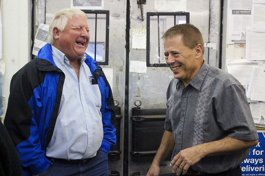 Greg Wellman and Paul Keen laugh together Friday morning at Portland Post Office. Keen celebrated his retirement this week after working for the office more than 39 years. He and Wellman — another former Portland Post Office worker who retired last year — attended Bloomfield Elementary School around the same time. (The Commercial Review/Bailey Cline)