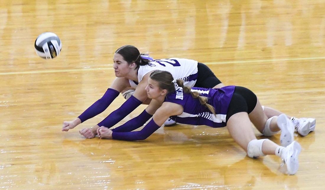 Fort Recovery High School’s Bridget Homan (white) and Kayla Gaerke (purple) dive on the floor to try and receive a serve from No. 2 St. Henry during the OHSAA Division VI Regional 24 final on Saturday at Northmont. The Tribe kept up with its neighbors in the first set, but a St. Henry timeout ended a 6-0 FRHS run and SHHS proceeded to control the rest of the match, outscoring Fort Recovery 63-17. (The Commercial Review/Andrew Balko)
