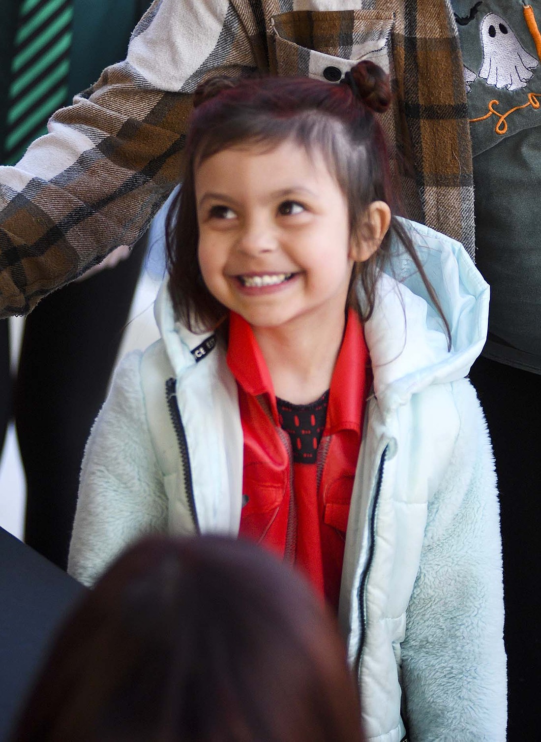Jaylee Franks, 5, grins Friday night at one of the stops during the Jay County Chamber of Commerce Trick-or-Treat in downtown Portland. Franks dressed up as Princess Red of Wonderland from Disney’s Descendants franchise. (The Commercial Review/Ray Cooney)
