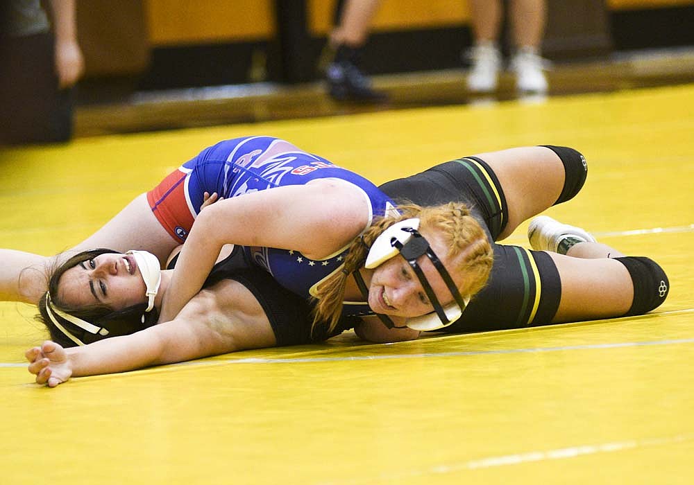 Alayna Willoughby of Jay County High School pins Northeastern's Sophia Campbell for her first career victory during Saturday's Monroe Central Invitational. The Patriots got big moments from several newcomers and first-place finishes from three veterans to win the tournament. (The Commercial Review/Ray Cooney)