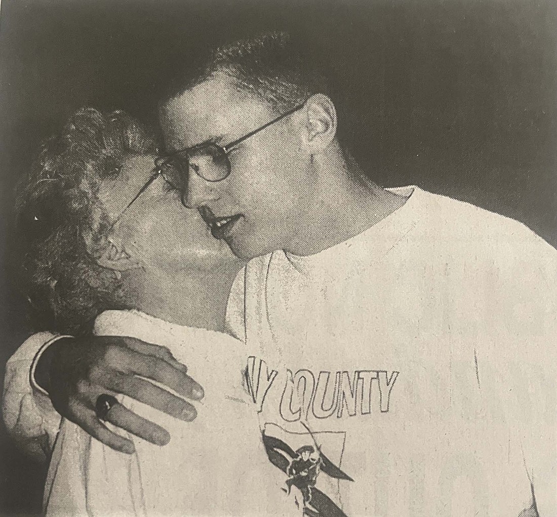 Gary Dennis gets a congratulatory hug from his grandmother Norma Coons on Nov. 14, 2000, after the American Red Cross recognized him for his efforts to help a stabbing victim two weeks earlier. (The Commercial Review/Laurie Chen)