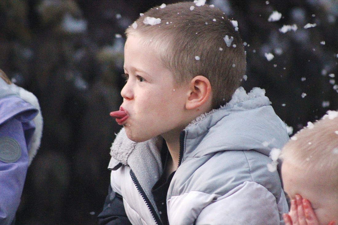 Henry Vagedes, 5, sticks his tongue out for artificial snowflakes at Krenning Park during Fort Recovery’s Christmas Open House festivities Thursday. Activities continue this weekend, with Santa Claus visiting from 11 a.m. to 1 p.m. today and noon to 4 p.m. Sunday. (The Commercial Review/Bailey Cline)