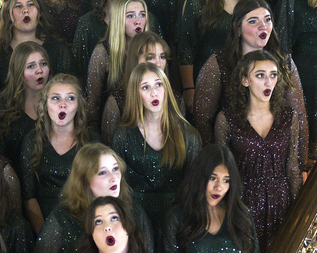 Members of the Jay County High School show choirs sing on the courthouse steps — and continued with the Parade of Lights on Saturday evening. (The Commercial Review/Ray Cooney)