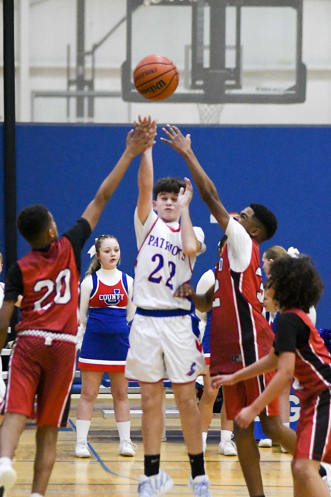 Jay County Junior High School seventh grader Benson Collins splits a pair of defenders to put up a shot during the Patriots’ 41-28 win on Monday. The victory pushed Jay County’s seventh grade team to 2-1 on the season, while the eighth graders’ 47-29 beating kept them undefeated at 3-0. (The Commercial Review/Ethan Oskroba)