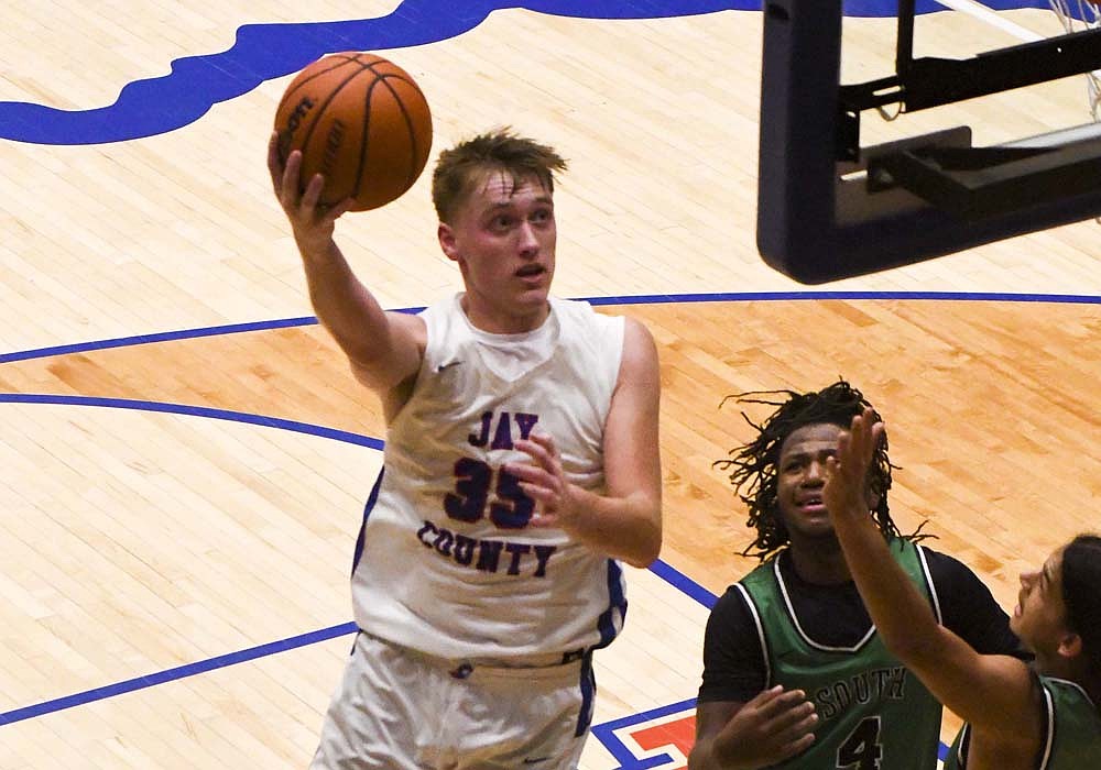 Gradin Swoveland of Jay County High School drives to the rim in the second half of the Patriots’ season-opening 64-57 loss to Fort Wayne South Side on Tuesday. Swoveland was one of three JCHS players to score in double figures, finishing with 15 points. (The Commercial Review/Ethan Oskroba)
