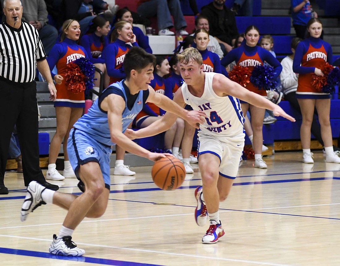 Benson Barnett of the Jay County High School boys basketball team pressures Camden Brooks of Woodlan up the floor during Friday’s 52-28 victory in the Allen County Athletic Conference opener. Barnett forced a 10-second violation and scored a bucket off an offensive rebound and a step through as part of a 15-5 run that pushed the Patriots over the top in the win. (The Commercial Review/Andrew Balko)