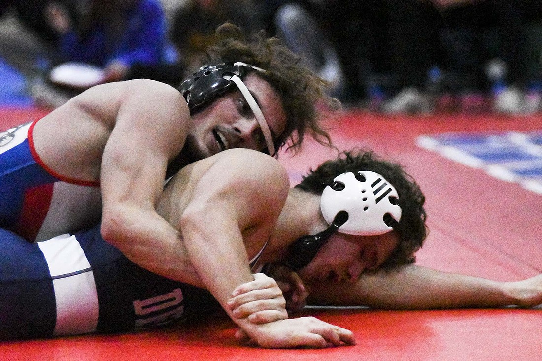 Jason Landers of the Jay County High School boys wrestling team controls the right wrist of the Delta Eagles’ Jackson Teal during Tuesday night’s dual. Landers won the match in the 144-pound division by an 8-3 decision, helping the Patriots vanquish Class 2A No. 5 Delta 43-27. (The Commercial Review/Ethan Oskroba)