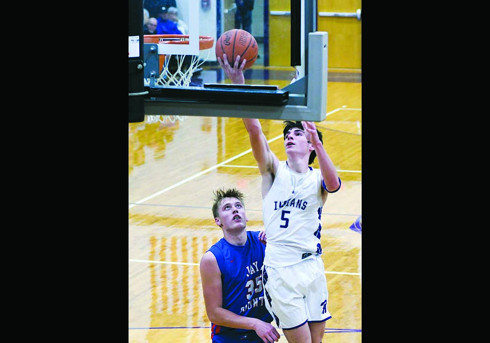 Brody Barga of the Fort Recovery High School boys basketball team drives past the Jay County Patriots’ Gradin Swoveland during the Indians’ 49-40 win over the Patriots on Saturday. (The Commercial Review/Andrew Balko)