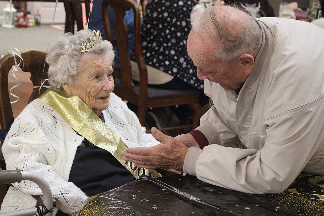 Maxine Aker chats with a friend Saturday during her 100th birthday celebration at CrownPointe in Portland. The longtime Jay County resident owned and operated Aker’s General Store in Salamonia with her husband, Bob, for decades. (The Commercial Review/Bailey Cline)