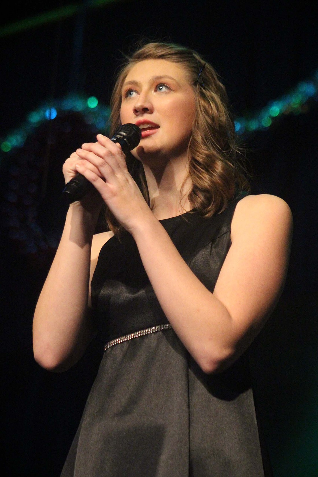 Fort Recovery High School senior Leah Wuebker sings “What Child Is This?” during the choir concert Sunday at Fort Recovery Elementary and Middle School auditorium. Other selections included “Yule Be Rockin” and “Christmas Dreams” by the high school choir and “Hot Chocolate” and “Believe” from “The Polar Express” by the junior high choir. (The Commercial Review/Bailey Cline)