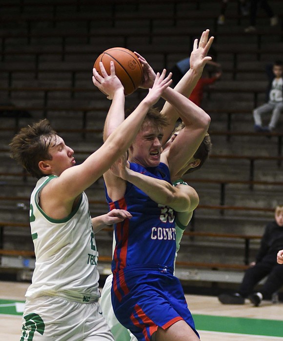 JCHS forward Gradin Swoveland gets sandwiched by New Castle’s Braylen Bennett (front) and Nick Godby during Monday’s 58-41 win. Swoveland scored 10 points, grabbed four rebounds and dished out two assists in the game. (The Commercial Review/Andrew Balko)