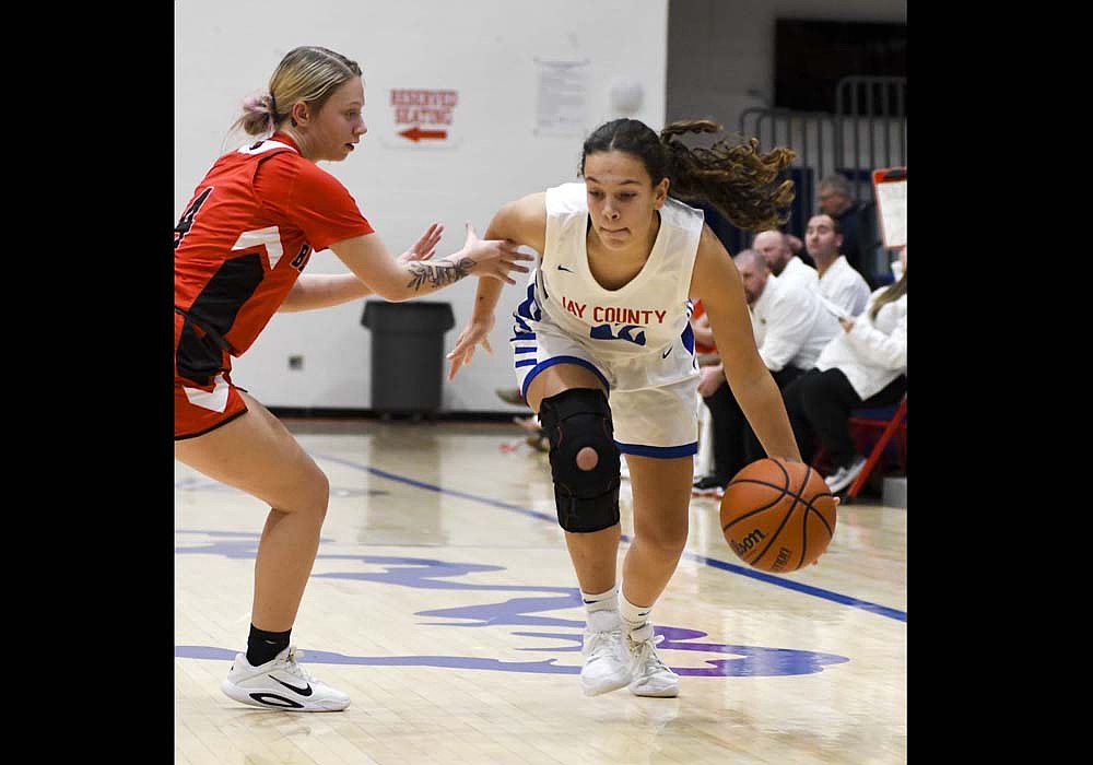 Jay County High School foreign exchange student Araitz Lekue Magro drives past Blackford’s Kaylor Hedge during Tuesday’s 56-19 victory. Lekue Magro ripped down five rebounds to contribute to a 44-17 advantage for the Patriots on the glass.­­­ (The Commercial Review/Andrew Balko)