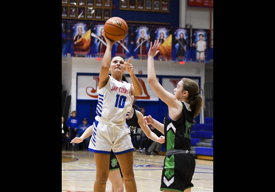 Raylah Newton of the Jay County girls basketball team pushes up a shot during the Patriots’ 75-58 win over the New Castle Trojans on Thursday. Newton finished with nine points on 4-of-7 shooting. (The Commercial Review/Ethan Oskroba)