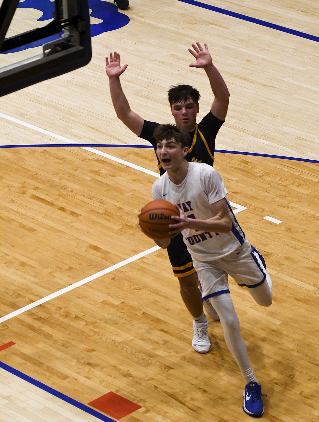 Jayden Comer of the Jay County High School boys basketball team drives around Delta’s Ryan Lynch during Friday’s  36-30 victory. Comer scored 12 points while helping limit the Eagles starting guards to just 14 points in the contest. (The Commercial Review/Ethan Oskroba)