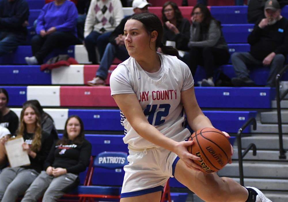 Charlee Peters of the Jay County High School girls basketball team turns her torso to try and save a ball that’s heading out of bounds during Saturday’s 75-44 win over South Adams. Peters scored a career-high 16 points  to join Raylah Newton, Hallie Schwieterman and Karsyn Schwieterman in double figures. (The Commercial Review/Andrew Balko)