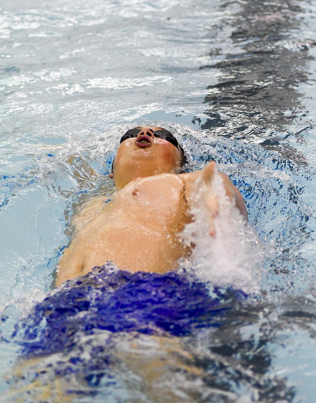 Matthew Fisher swims the 100-meter backstroke on Dec. 5 when the Jay County High School swim team took on the Bluffton Tigers. On Monday, both the JCHS boys and girls teams beat Adams Central to round out the regular season meets against Allen County Athletic Conference teams. (The Commercial Review/Andrew Balko)