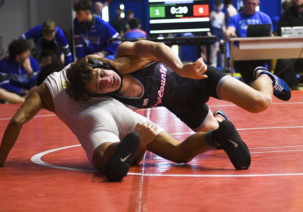 Alex Rivers of Jay County High School attacks against Daniel Rupp of South Adams during their 126-pound championship match in Saturday's East Central Indiana Classic. Rivers won the match 19-2 by technical fall as he and 120-pounder Silas Wenk earned championship for the host Patriots. (The Commercial Review/Ray Cooney)