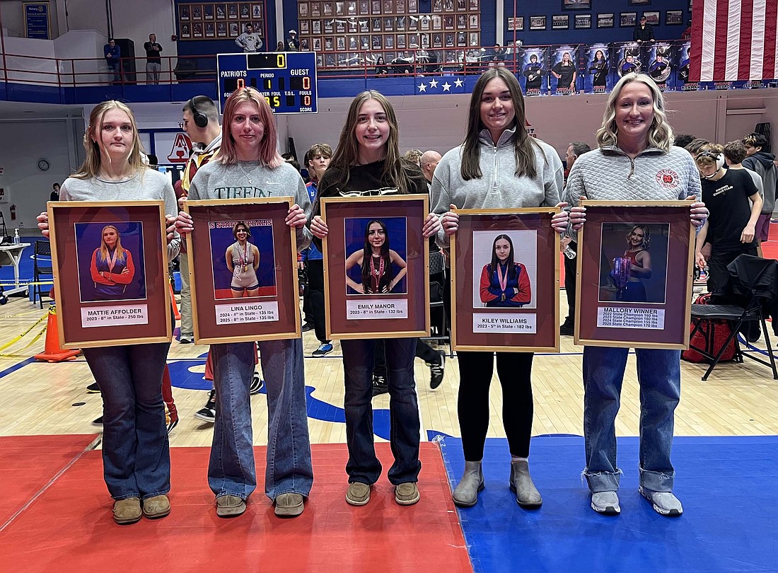 Jay County High School added five wrestlers to its Wall of Fame during Tuesday’s East Central Indiana Classic. Inductees, pictured from left, are 2025 graduates and state medalists Mattie Affolder, Lina Lingo, Emily Manor, Kiley Williams and Mallory Winner. Winner was  a four-time state champion, including winning the inaugural IHSAA state title for girls wrestling at 170 pounds in 2025. Lingo was a two-time state medalist, including a fourth-place finish in 2024, and Affolder, Manor and Williams each earned one state medal. (The Commercial Review/Ray Cooney)