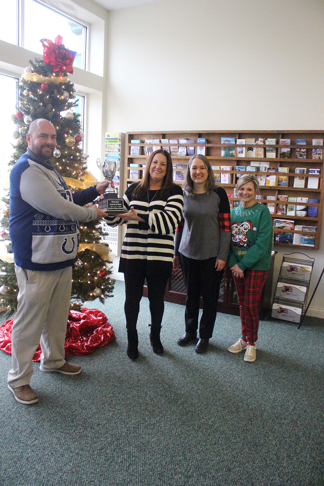 Jay County Chamber of Commerce announced Festival of Trees winners Dec. 18. Pictured at left are People’s Choice Award winner Youth Service Bureau with representative PJ Corwin, chamber director Amanda Nixon-Randall, Jay County Public Library children’s services librarian Shana Neuenschwander and Tami Vormohr. Above are third place winner Jay County Drug Prevention Coalition with executive board member Doug Johnson, Nixon-Randall, Neuenschwander and Vormohr. (The Commercial Review/Bailey Cline)
