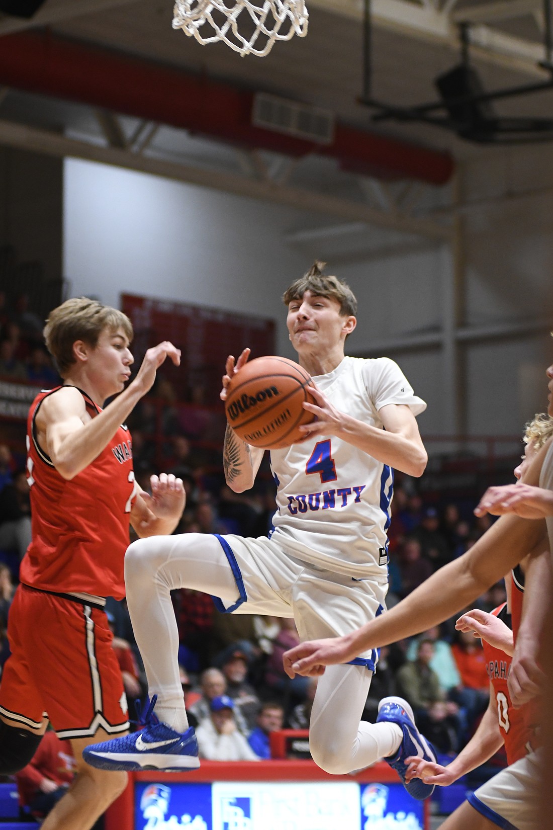 Jayden Comer of the Jay County High School boys basketball team drives to the basket during the Patriots' 60-55 win over the Wapahani Raiders on Saturday. Comer set a new season-high and tied his career-high with 23 points in the victory. (The Commercial Review/Ethan Oskroba)