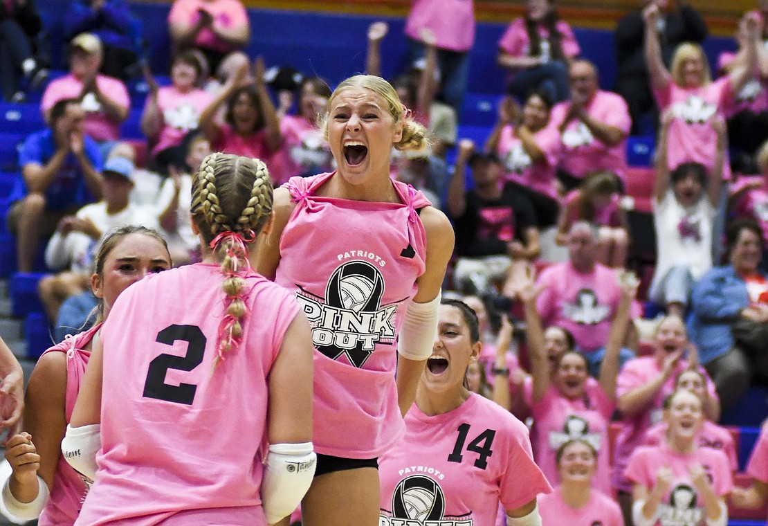 JCHS junior Hallie Schwieterman screams at Elizabeth Barnett (2) after rallying in the fourth set as the Patriots secured the outright Allen County Athletic Conference regular-season volleyball championship with a win Oct. 2 over Class 3A No. 7 Heritage. (The Commercial Review/Andrew Balko)