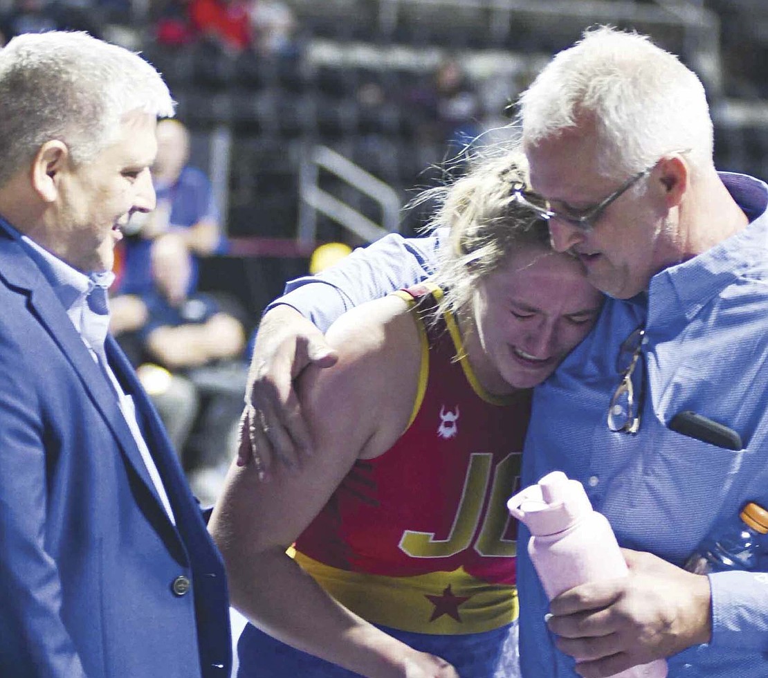 JCHS senior Mallory Winner tears up while hugging assistant coach and father Jon Winner following the inaugural IHSAA 170-pound state championship match on Friday at Corteva Coliseum at Indiana State Fairgrounds. No. 1 Winner pinned No. 11 Lydia Kwaleh of Perry Meridian after 2 minutes, 50 seconds. (The Commercial Review/Andrew Balko)