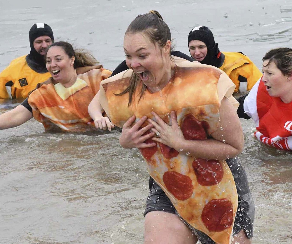 Abby Brockman rushes back out of the pond northwest of Moser Engineering during United Way of Jay County’s Peggy’s Plunge. The polar plunge in honor of Peggy Atkinson raised money for Jay County’s Special Olympics, cancer society and homeless shelter. (The Commercial Review/Andrew Balko)