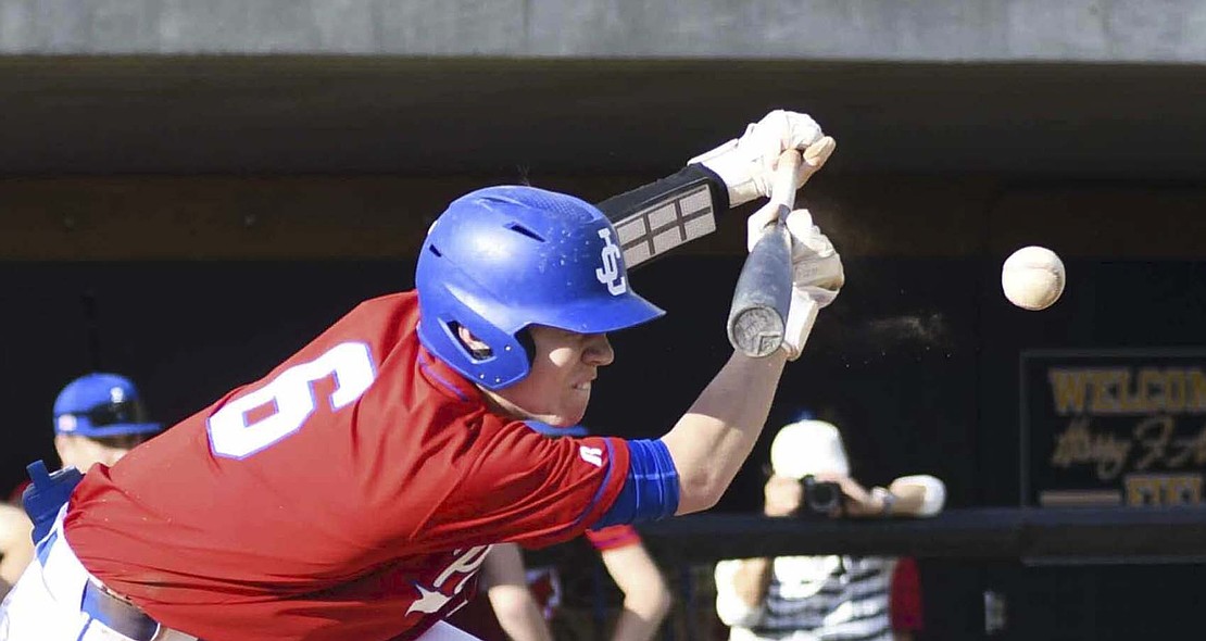 Wyatt Foster, the No. 2 hitter in the Jay County High School baseball team’s lineup, gets low as he tries to lay down a bunt at South Adams on May 8. Foster drew a walk in the at-bat to drive in a run. The Patriots beat the Starfires 11-0 to pick up their second Allen County Athletic Conference win of the season. (The Commercial Review/Andrew Balko)