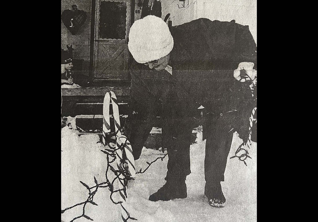 Twenty-five years ago this week, Portland residents were taking down their holiday decorations. Pictured from the Jan. 3, 2001, edition of The Commercial Review, Karen Alexander picks up a strand of Christmas lights at her home at 615 W. Arch St., Portland. Alexander had put up the decorations over the Thanksgiving 2000 weekend. (The Commercial Review/Laurie Chen)
