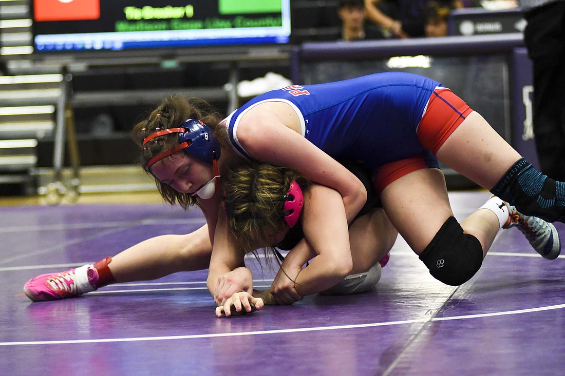 Madison Gage of the Jay County High School girls wrestling team works on Wes-Del’s No. 15 Sophia Gropp during the IHSAA Sectional 10 hosted by Muncie Central on Friday. Gage took the two-time state qualifier all the way to the ultimate tiebreaker but got called for locking hands three seconds before she would have won on a rideout. (The Commercial Review/Andrew Balko)